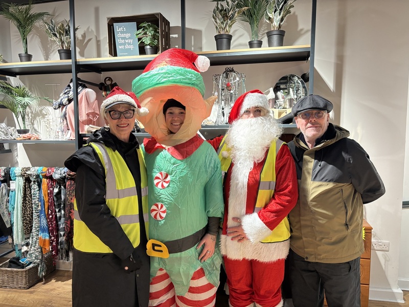 volunteers-inside-a-shop-dressed-in-christmas-outfits-and-hi-vis-vests