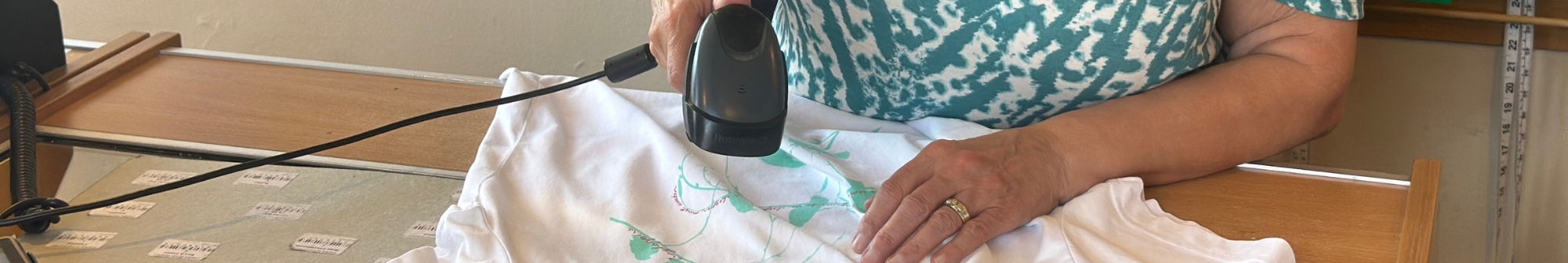 volunteer-shop-assistant-scanning-a-t-shirt