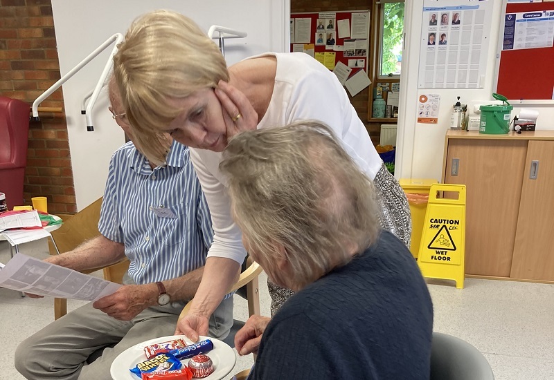 volunteer-patsy-hands-out-biscuits-to-community-members