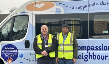 two-volunteer-drivers-and-chaperones-smiling-outside-the-minibus