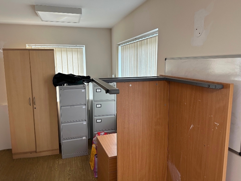 office-furniture-piled-up-in-the-corner-of-a-room