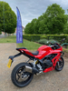 red-motorbike-parked-in-front-of-a-garden-house-hospice-care-flag
