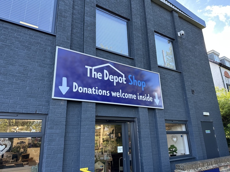 exterior-of-a-building-with-sign-reading-the-depot-shop-donations-welcome-inside