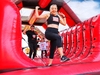 woman-smiling-at-camera-while-on-an-obstacle-at-the-inflatable-5k