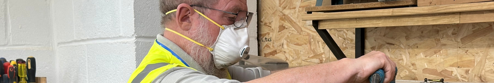 upcycling-house-volunteer-sanding-a-piece-of-furniture