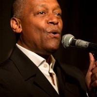 roy-gayle-from-frank-the-cat-signing-into-a-microphone
