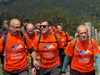 group-of-people-walking-towards-camera-wearing-matching-orange-t-shirts