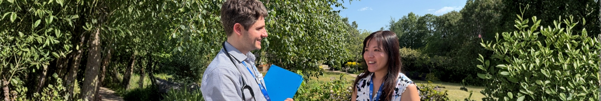 two-doctors-having-a-conversation-in-the-hospice-gardens