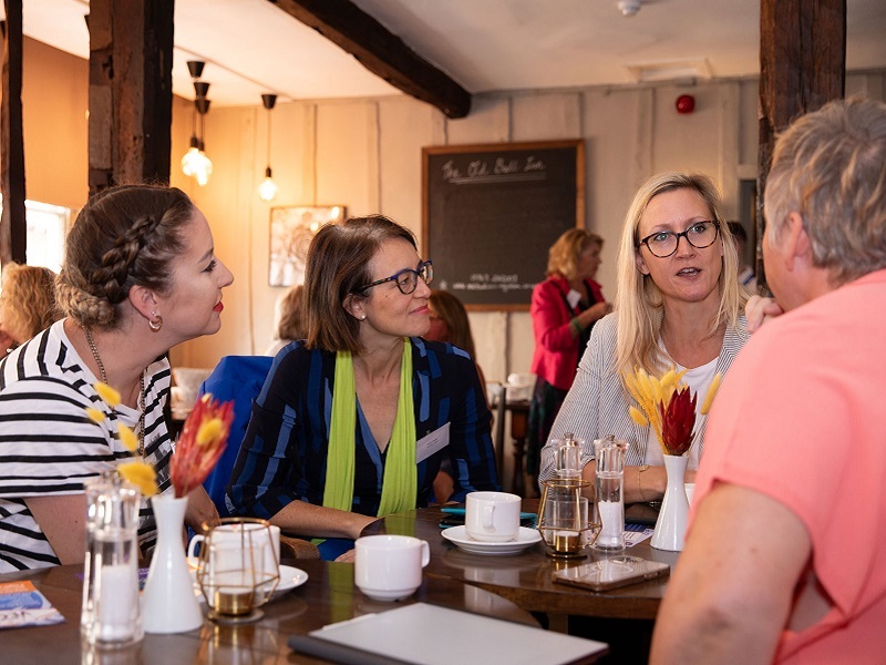 connect-members-and-guests-sit-around-a-table-talking