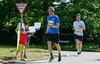 children-hold-up-signs-as-half-marathon-runner-passes-them