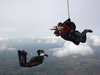 side-view-of-person-skydiving-with-photographer-beneath-them