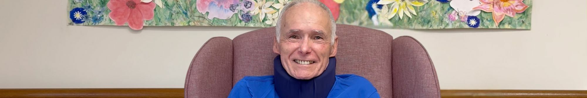 kent-smiles-sitting-in-a-chair-in-the-rehab-and-wellbeing-room