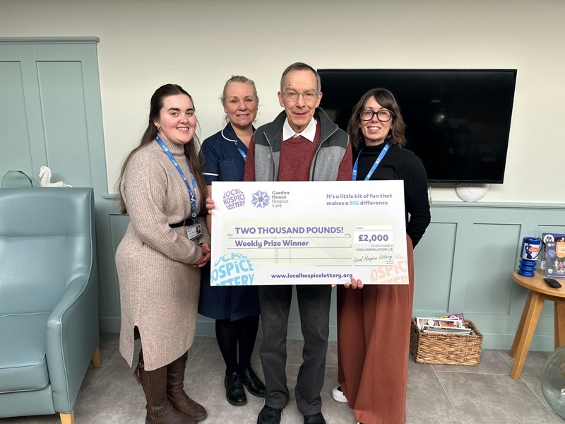 hospice-staff-with-mr-chetwin-holding-up-giant-cheque