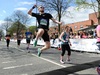 runner-jumping-and-punching-air-at-the-manchester-marathon