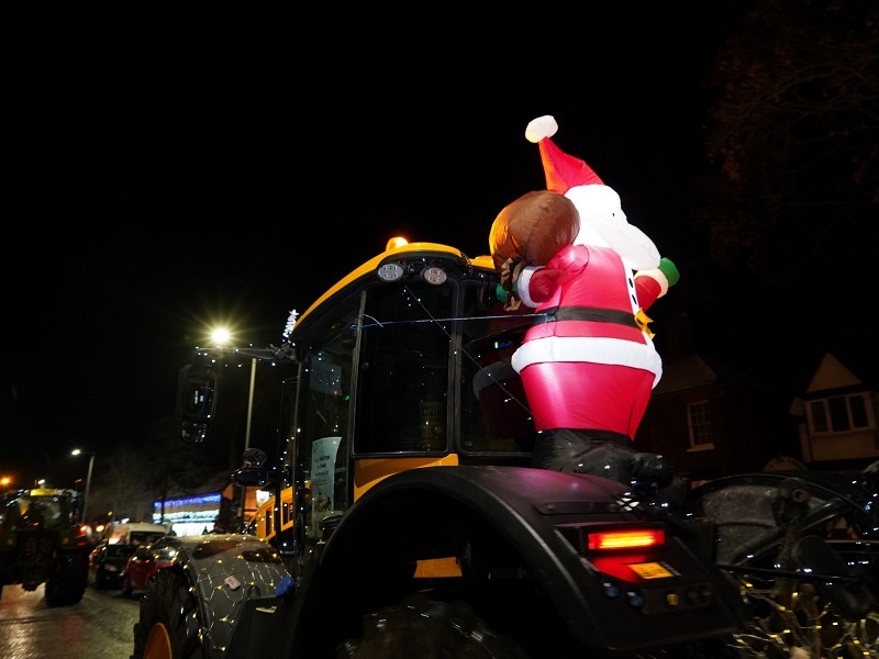an-inflatable-santa-claus-on-the-back-of-a-tractor
