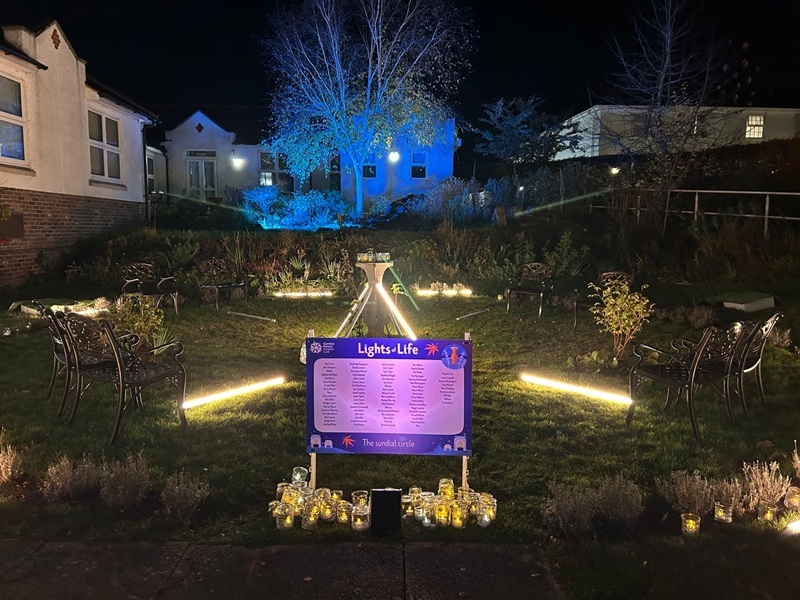 a-dedication-board-containing-names-illuminated-in-the-hospice-gardens