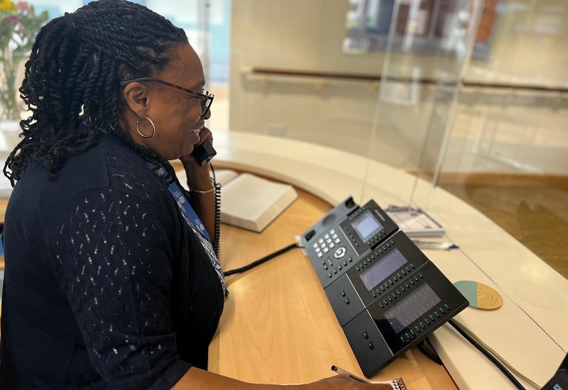 woman-smiling-on-phone-at-reception