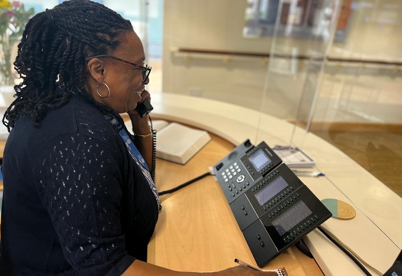 woman-smiling-on-phone-at-reception