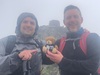 erman-and-adam-hold-up-teddy-bear-with-mountain-peak-in-the-distance