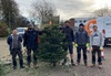 five-volunteers-standing-with-a-christmas-tree