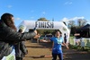 runner-high-fives-friend-in-crowd-as-she-crosses-the-finish-line