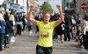 runner-celebrates-as-she-approaches-the-finish-line