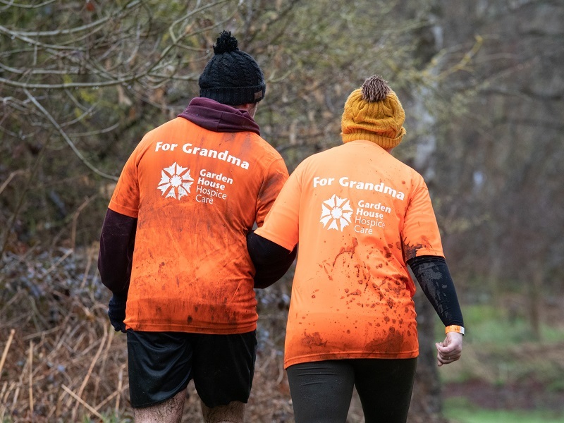 two-people-wearing-muddy-shirts-with-for-grandma-printed-on-the-reverse