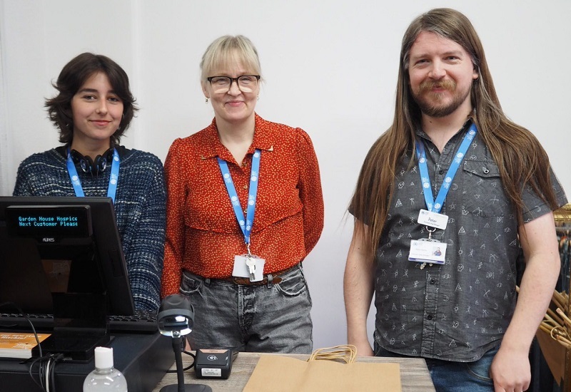 threads-volunteer-and-shop-managers-stand-behind-the-till